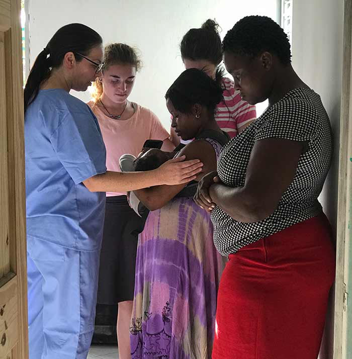 a doctor meeting with haitians in need